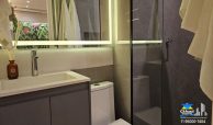 Apartamento decorado do PIM Vila Sônia com cozinha planejada integrada à sala